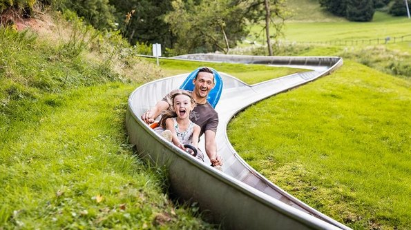 Sommerrodelbahn am Freizeitzentrum Peterberg Ein Mann und ein Kind nutzen die Sommerrodelbahn am Freizeitzentrum Peterberg